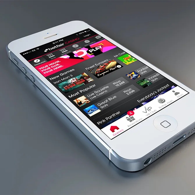 A white phone showing the Betfair Casino lobby, with game tiles including Iron Man 3 and Pink Panther.